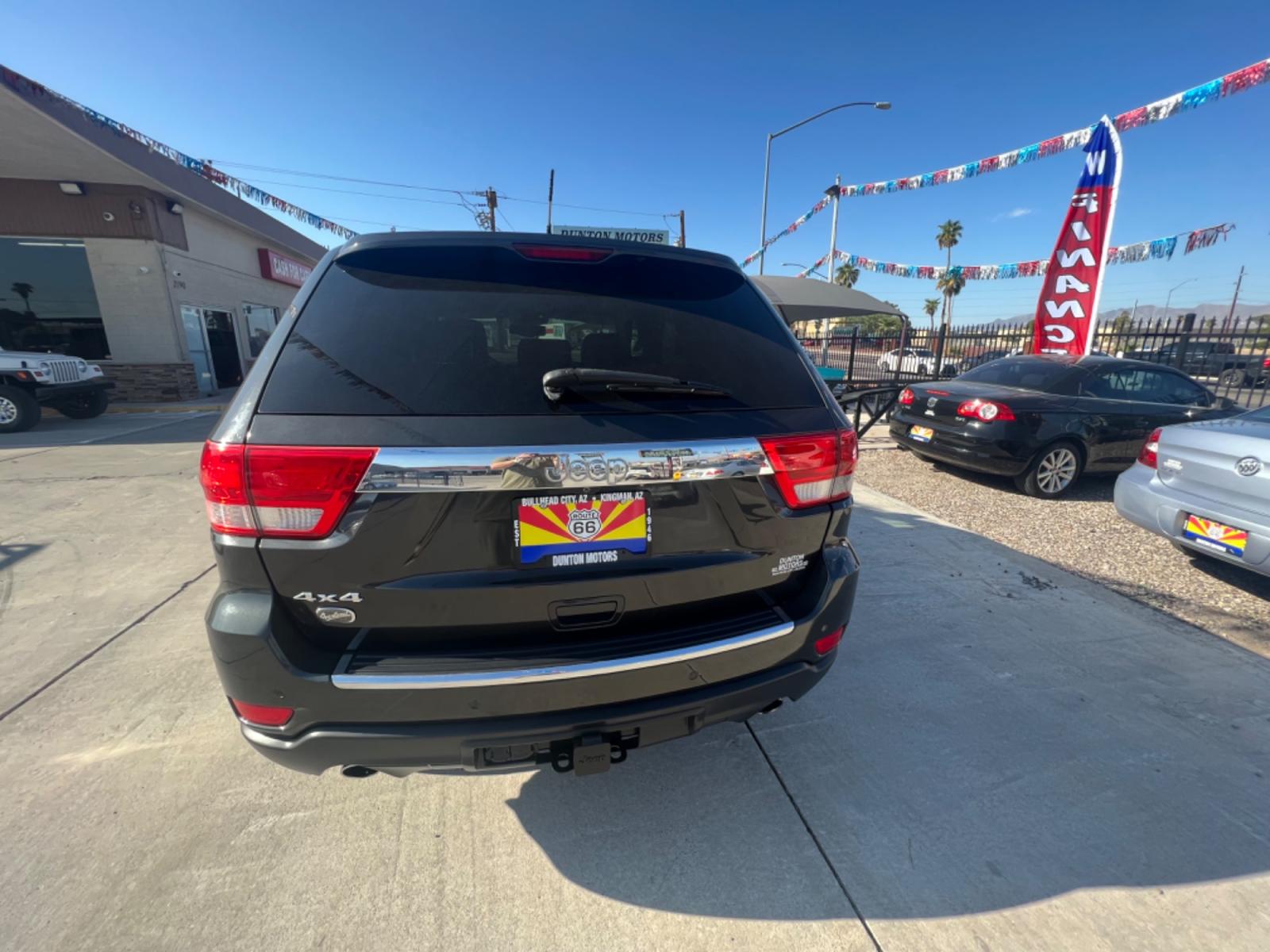 2011 Black Jeep Grand Cherokee Overland 4WD (1J4RR6GT8BC) with an 5.7L V8 OHV 16V engine, 5-Speed Automatic transmission, located at 2190 Hwy 95, Bullhead City, AZ, 86442, (928) 704-0060, 0.000000, 0.000000 - Photo #1