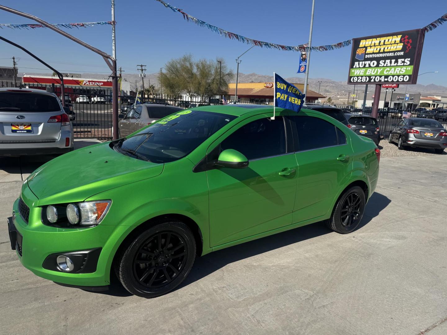 2015 Lime Green Chevrolet Sonic LT Auto Sedan (1G1JC5SB0F4) with an 1.4L L4 DOHC 24V TURBO engine, 6-Speed Automatic transmission, located at 2190 Hwy 95, Bullhead City, AZ, 86442, (928) 704-0060, 0.000000, 0.000000 - 1 owner. custom tires/ wheels. rare lime green color. we finance - Photo#1