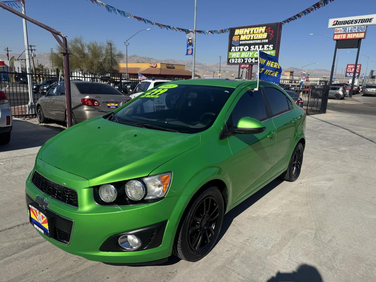 2015 Lime Green Chevrolet Sonic LT Auto Sedan (1G1JC5SB0F4) with an 1.4L L4 DOHC 24V TURBO engine, 6-Speed Automatic transmission, located at 2190 Hwy 95, Bullhead City, AZ, 86442, (928) 704-0060, 0.000000, 0.000000 - 1 owner. custom tires/ wheels. rare lime green color. we finance - Photo#4